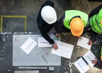 manufacturing workers and manager working with documents