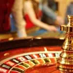 casino employee working at a roulette table