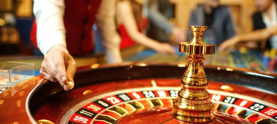 casino employee working at a roulette table