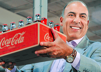 man holding up a case of coca-cola