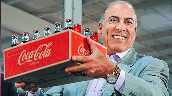 man holding up a case of coca-cola