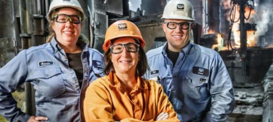 three waupaca foundry employees standing outside of a plant