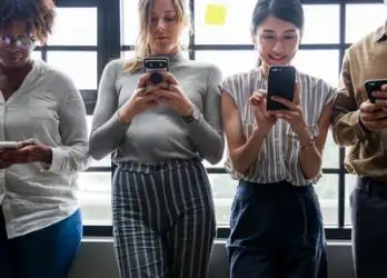 four people on their mobile phones