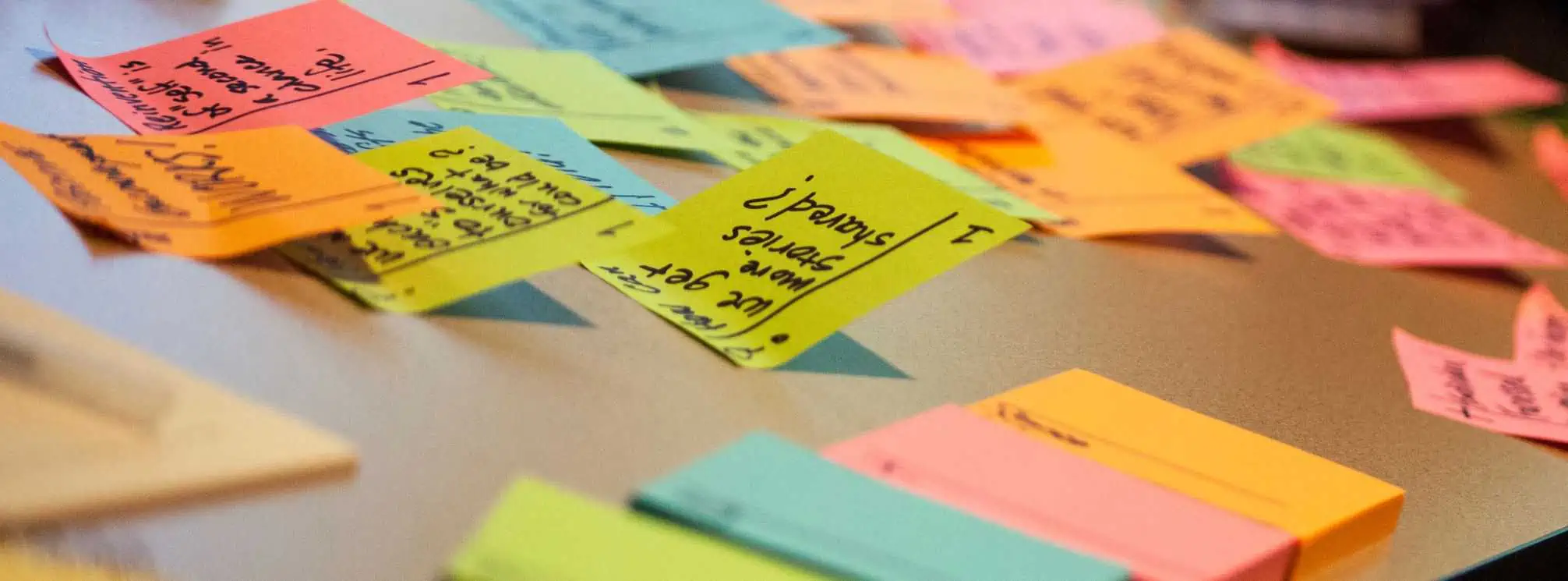 stick notes on a desk to represent planning a creative internal communications campaign