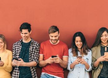 group of young millennials using smartphones