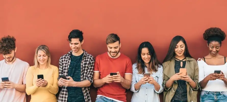 group of young millennials using smartphones