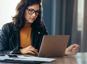 internal communications professional working on a laptop