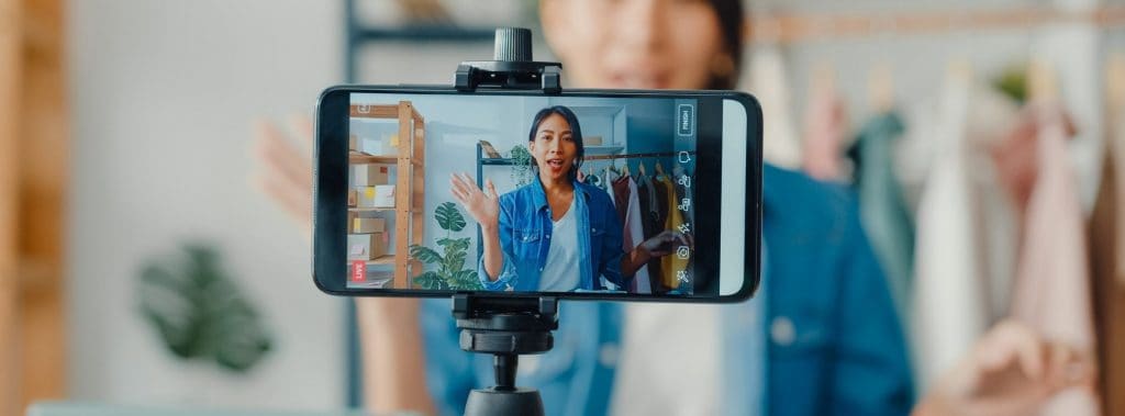 communicator filming video on smartphone