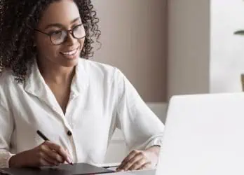 comms professional working on internal comms strategy on laptop