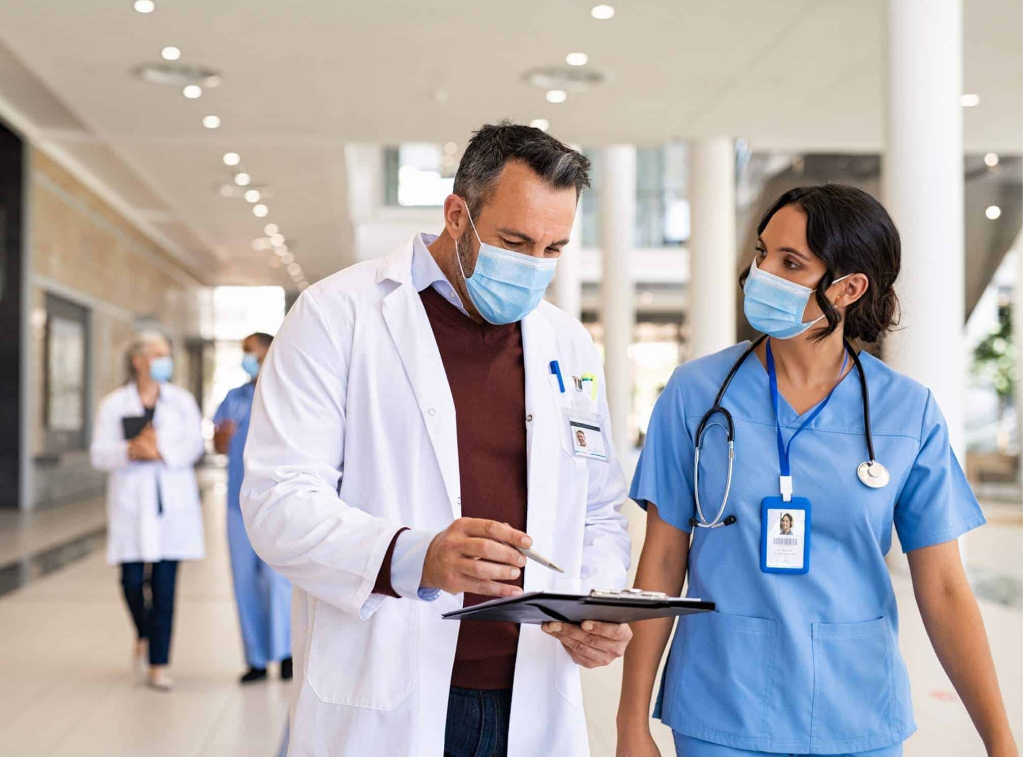 two frontline workers in healthcare communicating