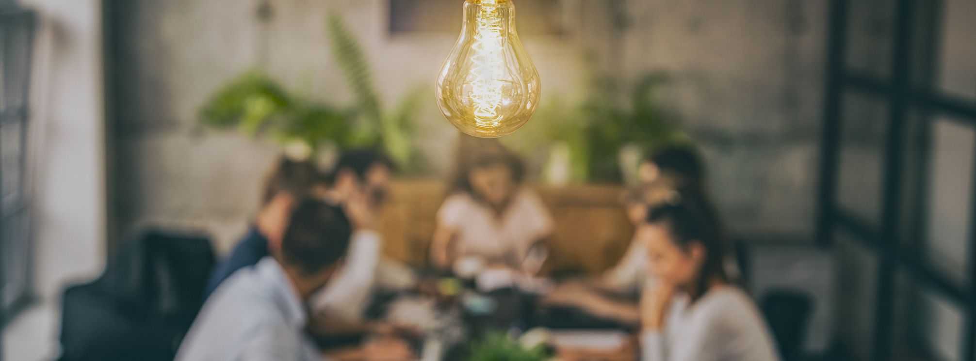 lightbulb going off over a team of people working