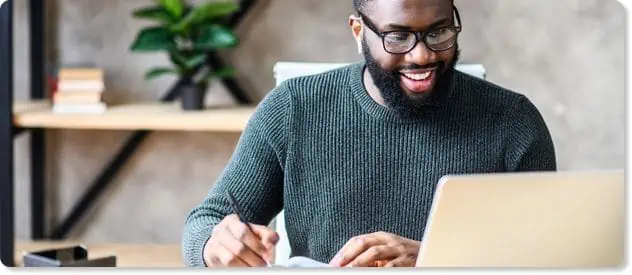 male professional working on his laptop to represent employee communication tools