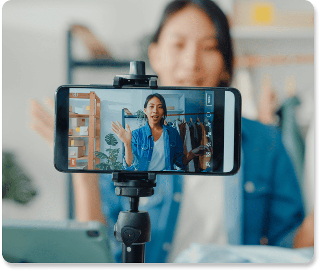 asian woman recording a video of herself on a smartphone for internal communication