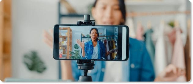 woman recording video on a smartphone to represent an internal communications tool