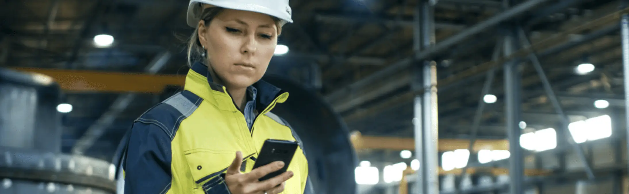 frontline manufacturing worker using personal phone at work