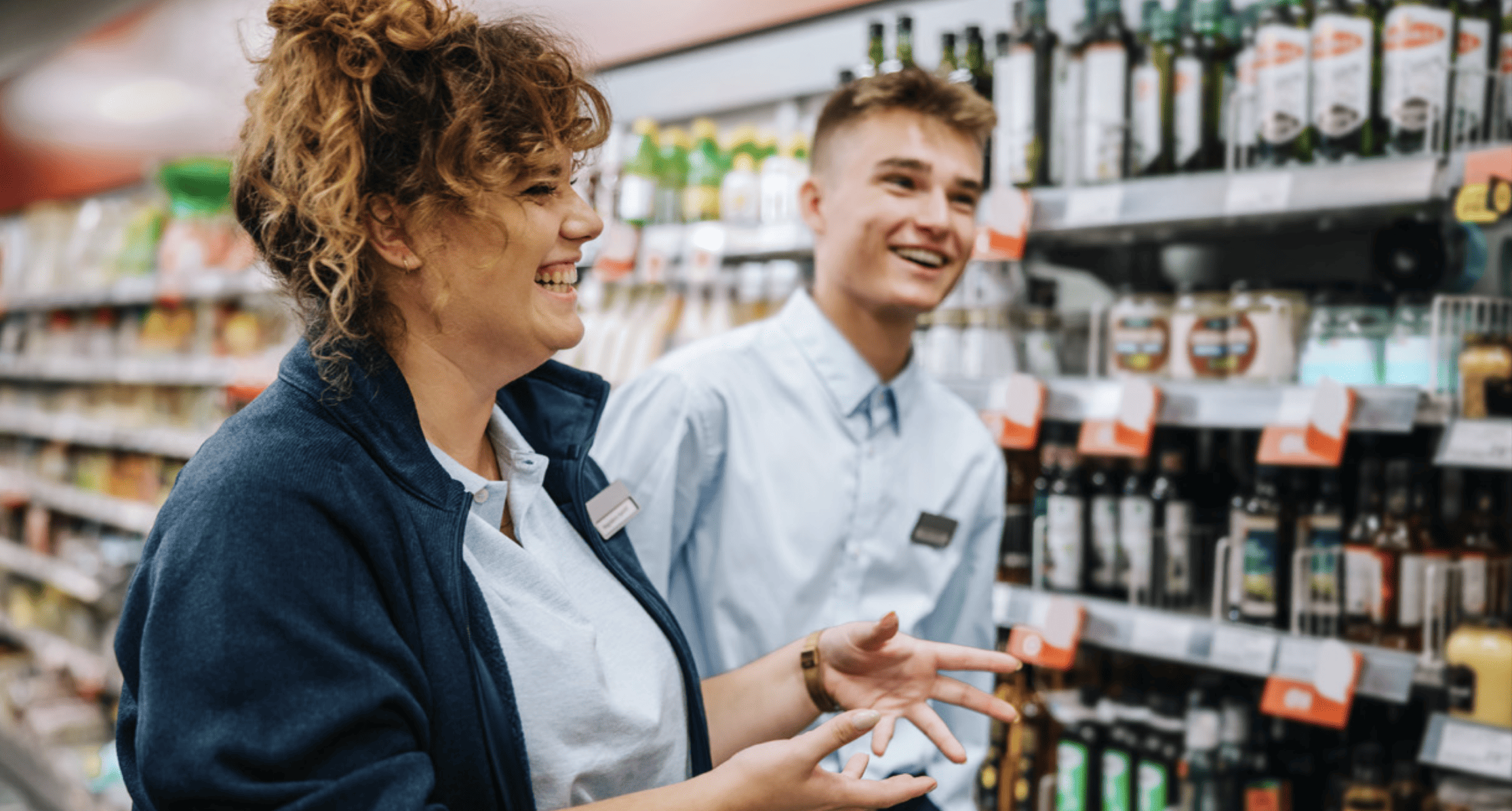 grocery store manager and employee smiling