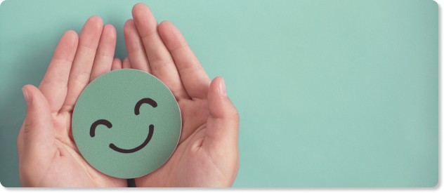 hands holding a smiley face to represent a positive employee experience