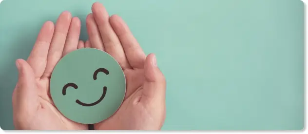 hands holding a smiley face to represent a positive employee experience