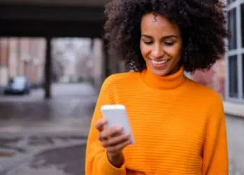 woman checking her texts outside of work