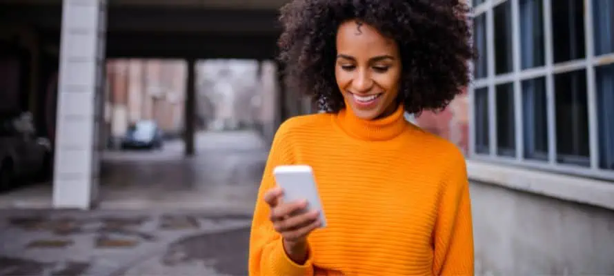 woman checking her texts outside of work