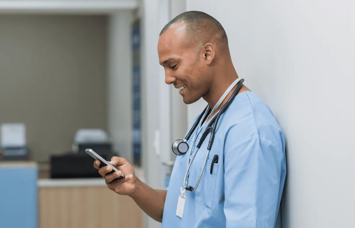 a male nurse (type of frontline worker) using his personal phone to view internal communication while at the hospital