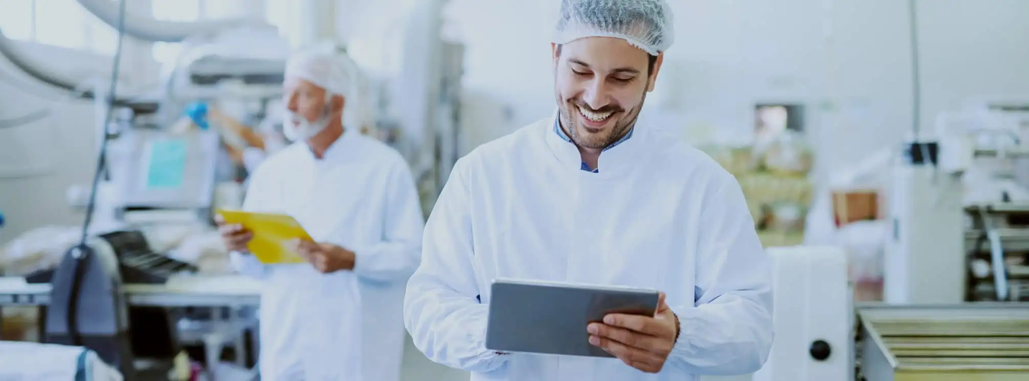 satisfied employee on the shop floor using a tablet