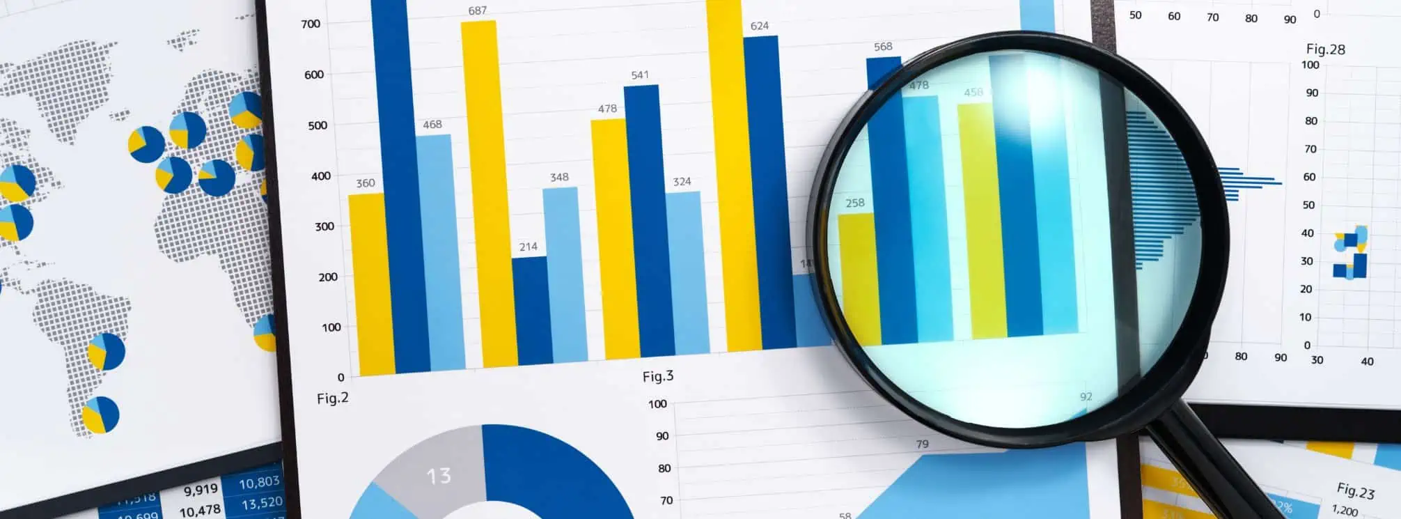 magnifying glass over a piece of paper with charts on them