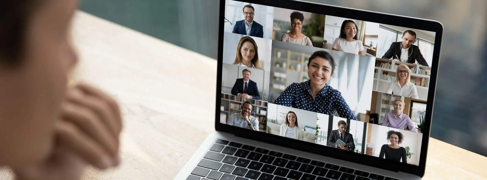 company meeting being held virtually on a laptop through conferencing software