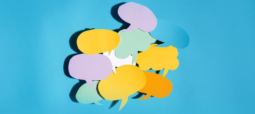 mass text employees represented by a pile of speech bubbles cut out of colorful construction paper on a blue gradient background