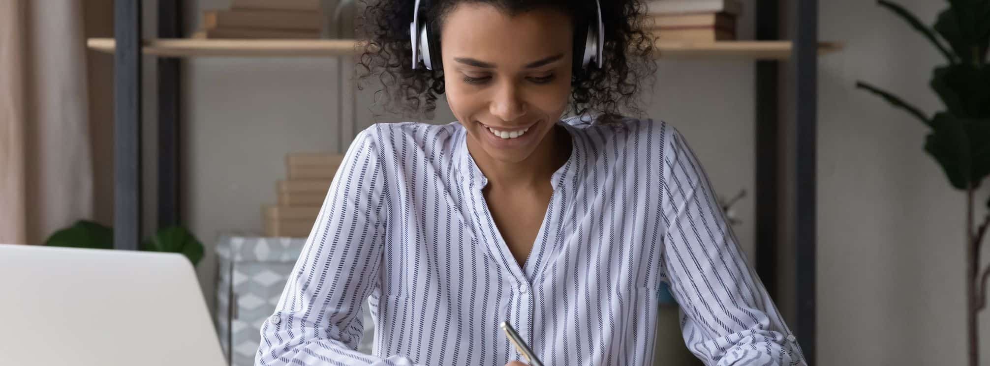 photo of a remote employee who is engaged and smiling while she's working at home