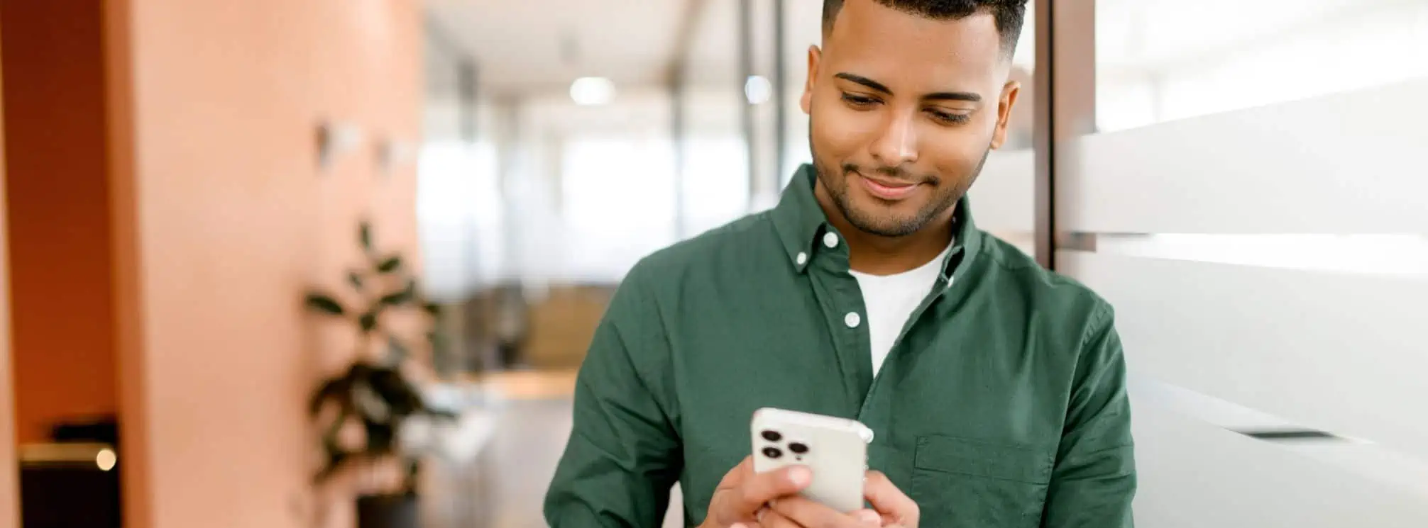 young man texting at work in the office