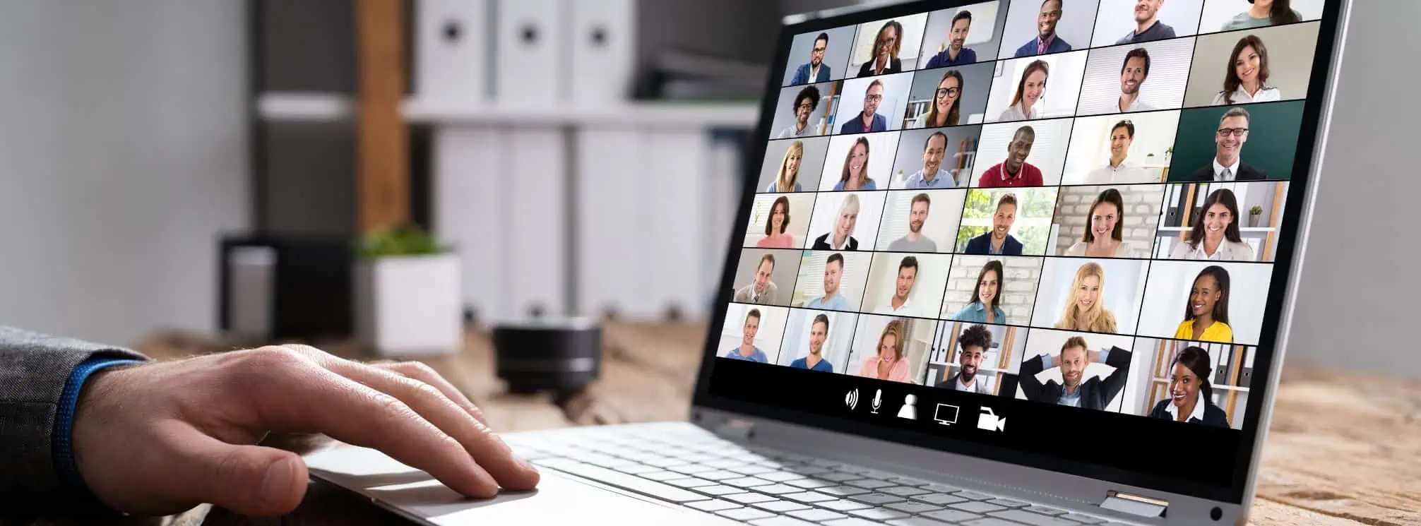 virtual town hall meeting pulled up on an employee's computer in their home office