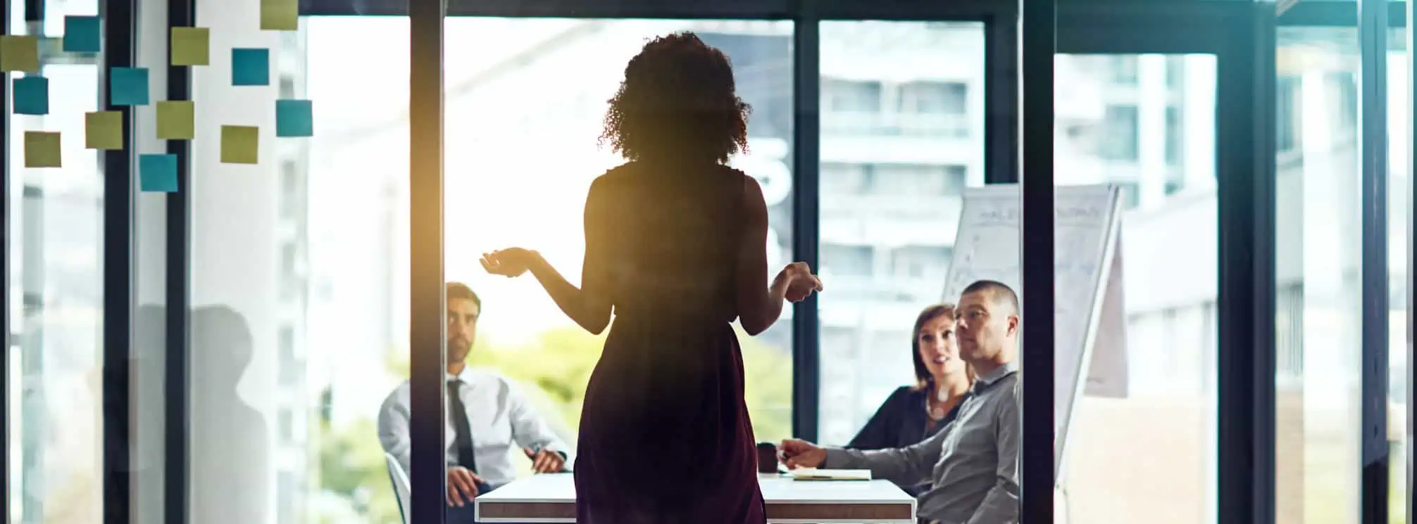 A woman leader in a conference room with her peers