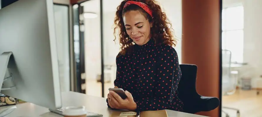 female professional at her desk receiving text messages for internal communication purposes