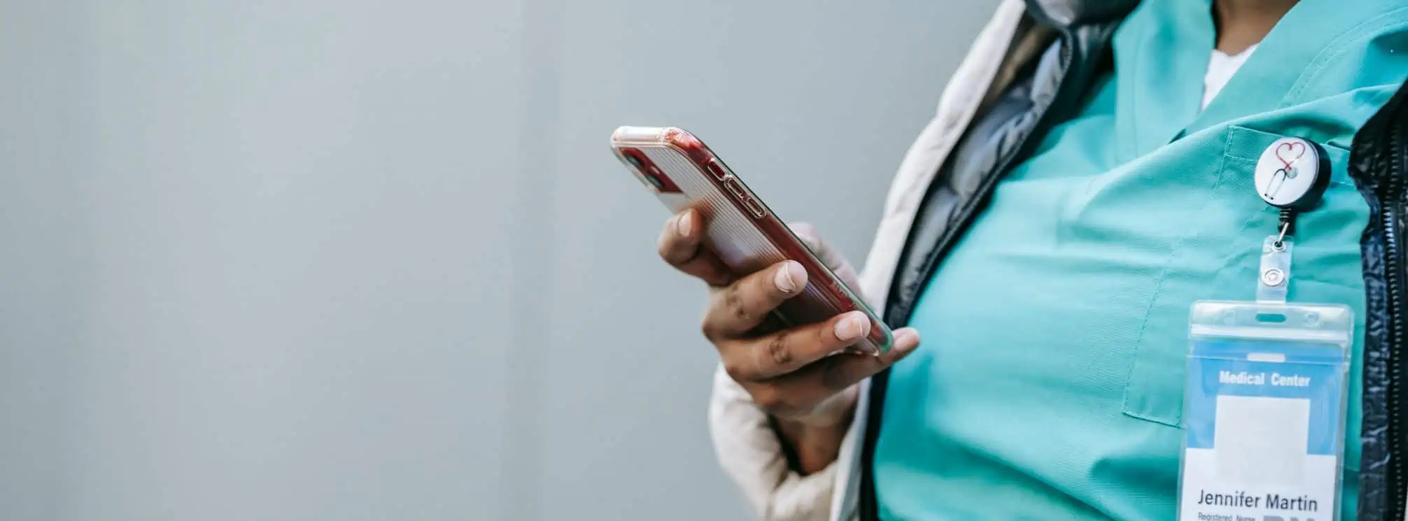 A registered nurse checking her phone in the hospital.