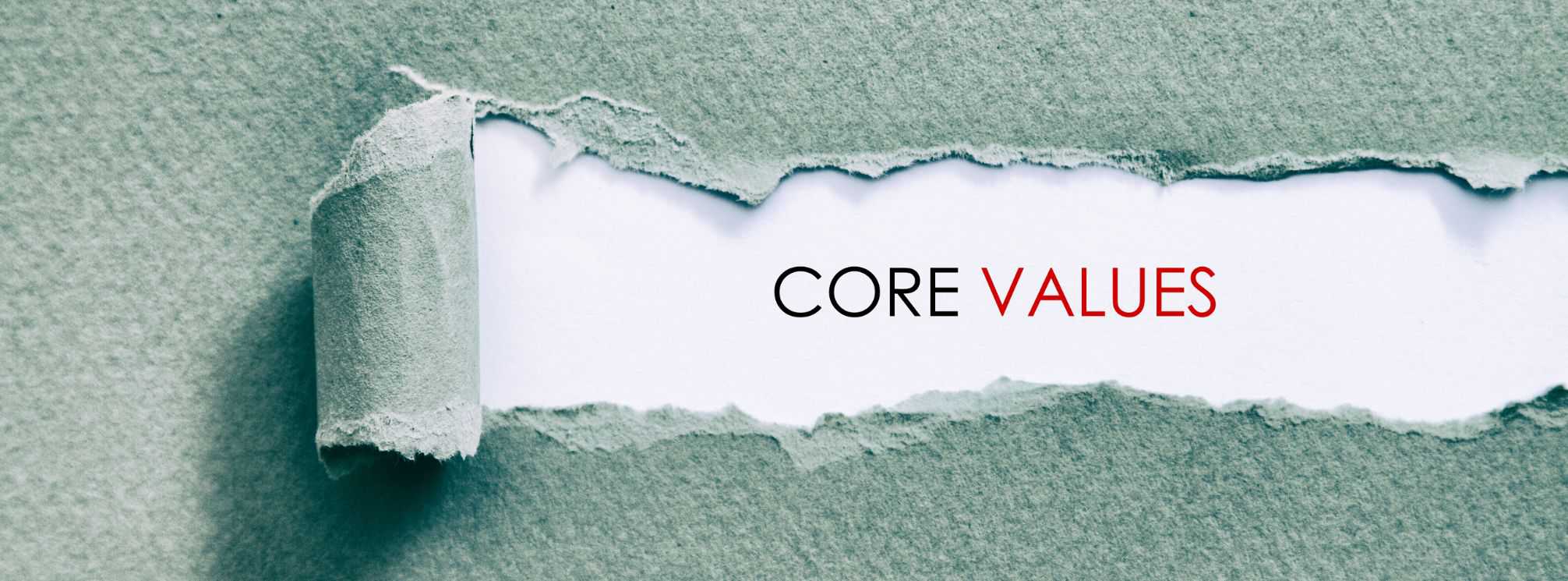 Piece of paper torn to reveal the words "core values" underneath.