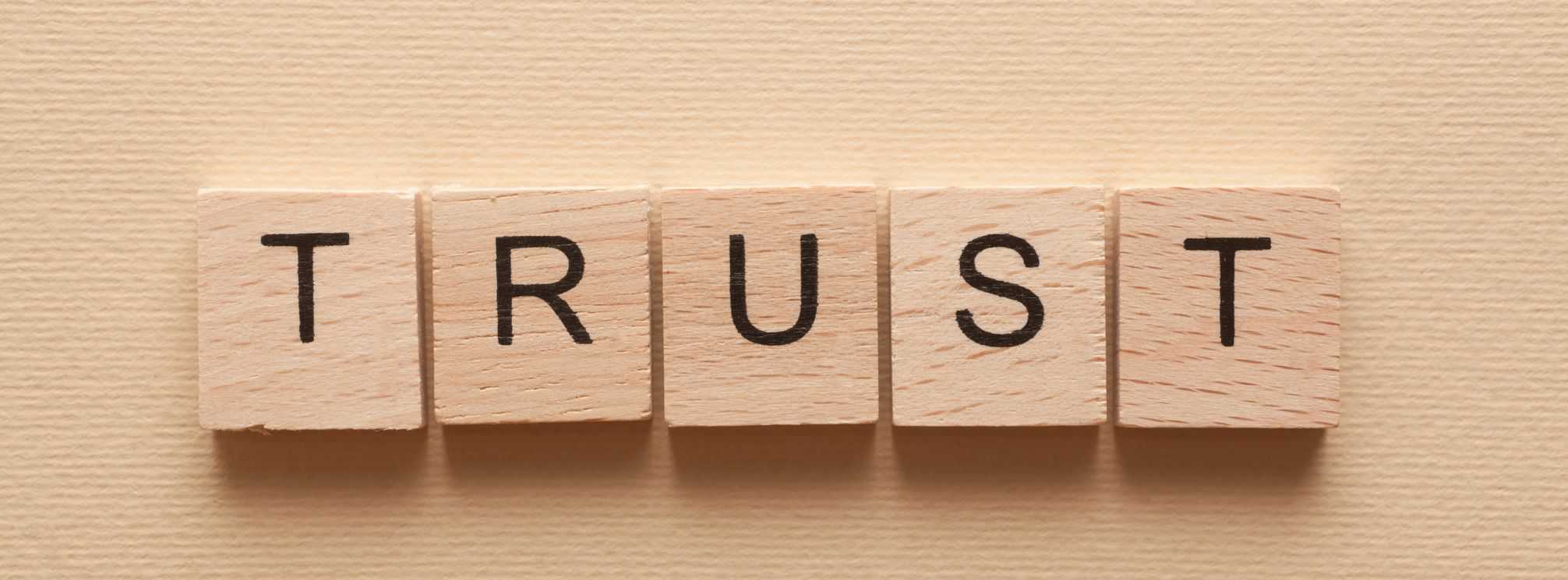 Scrabble tiles spelling the word "trust".