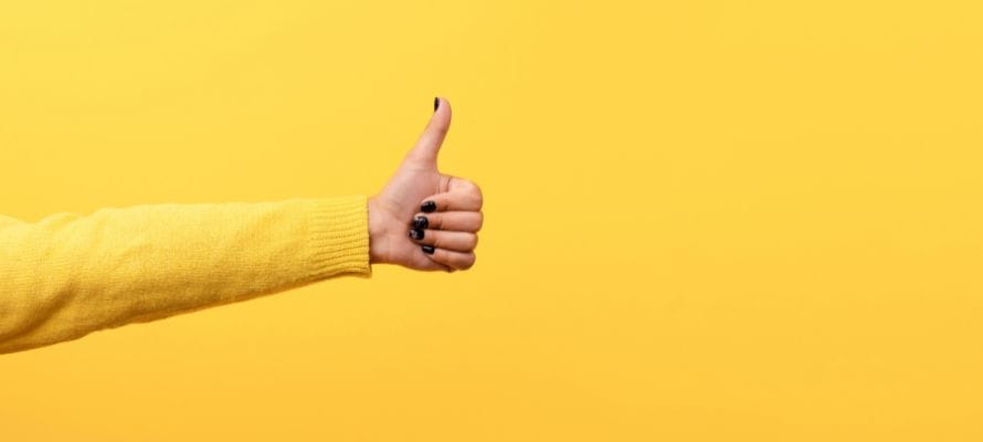 Bright yellow background with a woman's arm reaching out to give a thumbs up.